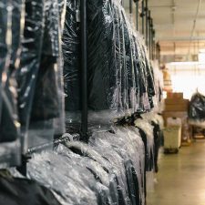 Clothes hanging in dry cleaning warehouse