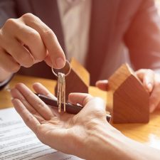 Person handing keys to a drycleaning property over to new property owners
