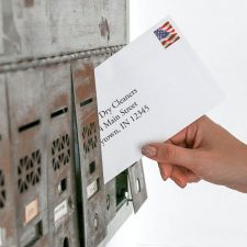 Drycleaner pulling demand letter from environmental agency out of mailbox