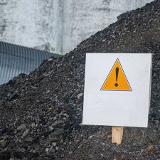 caution sign in pile of perc contaminated soil
