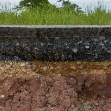 Cross-section look at the subsurface where PCE contamination can potentially transport through soil and into groundwater a great distance away from a drycleaning operation